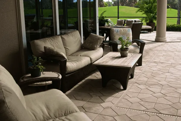 Covered paver patio with wicker outdoor seating