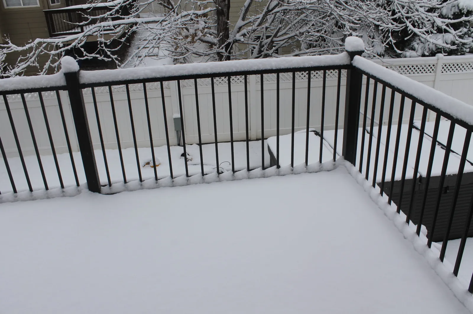winter-deck-care-colorado-snow-covered-railing Snow covered deck railing in Colorado showing winter deck care and freeze thaw conditions