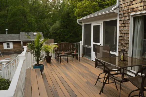 Wooden deck with white railing and patio furniture