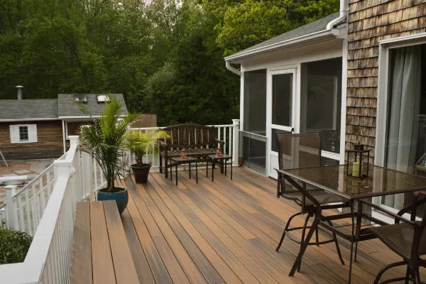 Wooden deck with white railing and patio furniture