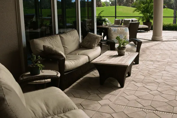 Covered paver patio with wicker outdoor seating