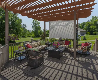 Wooden pergola over a deck with an outdoor seating area