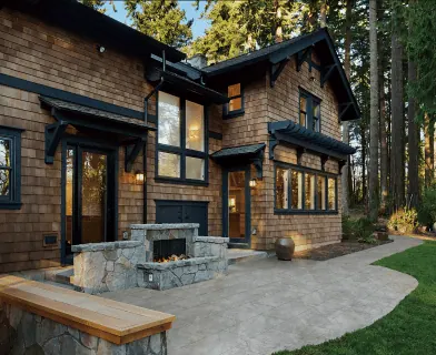 Stone outdoor fireplace on a backyard patio