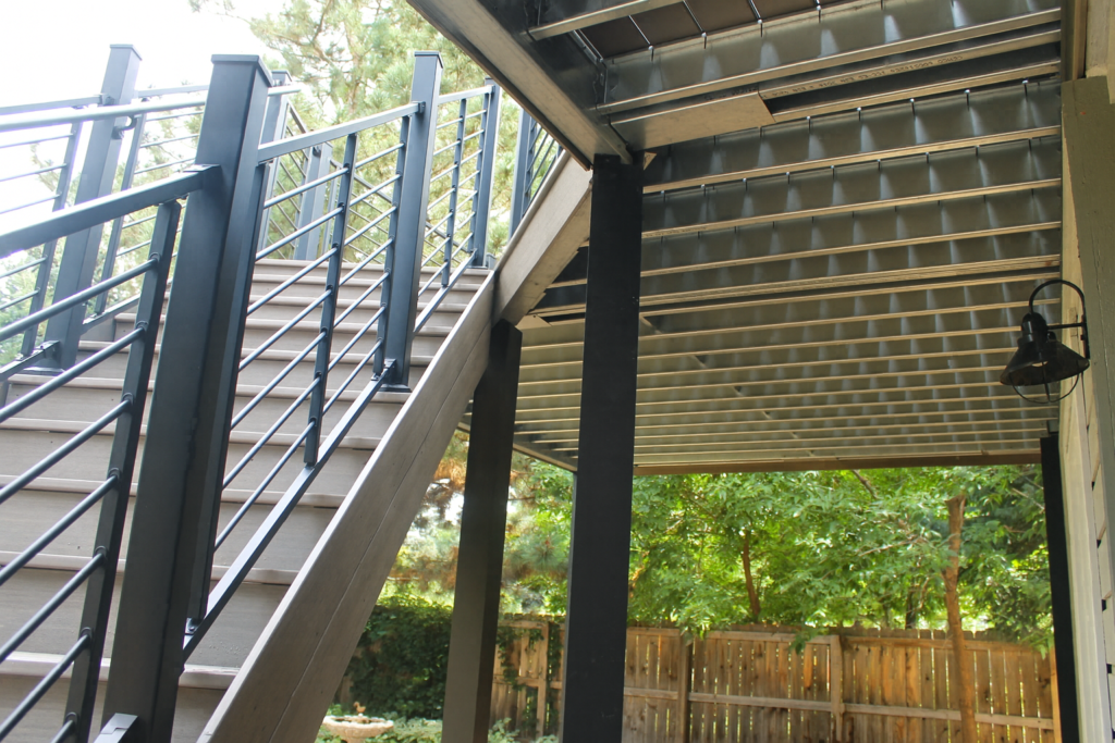 close-up of steel deck building showing steel frame, railing, and stairs designed for Colorado outdoor living